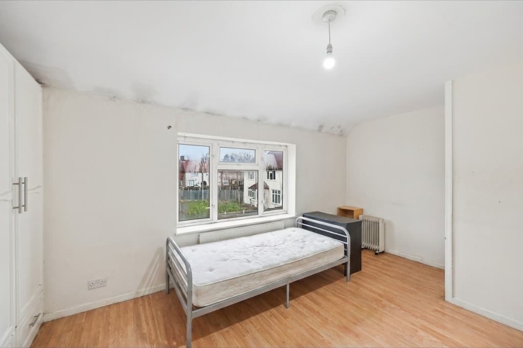 The same bedroom cleared of clutter and tidied by PhotoClear